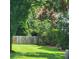 Private fenced backyard with lush landscaping and a brick-edged garden bed at 9411 Harroway Rd, Summerville, SC 29485