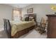 Bedroom featuring queen bed, wood frame, rocking chair and natural light from the side window at 9411 Harroway Rd, Summerville, SC 29485