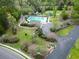 Aerial shot of community pool, tennis court, playground, fountain, and pond at 9411 Harroway Rd, Summerville, SC 29485
