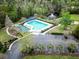 Aerial view of the community pool, parking, pond, and playground with fountain at 9411 Harroway Rd, Summerville, SC 29485