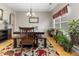 Charming dining room with a glass table and an abundance of natural light from a large window with plants at 9411 Harroway Rd, Summerville, SC 29485