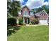 Charming brick home with a well-manicured lawn, garage and American flag at 9411 Harroway Rd, Summerville, SC 29485