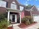 Charming brick two-story home featuring a classic front porch and a manicured front yard at 9411 Harroway Rd, Summerville, SC 29485