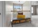 Hallway with a bench, decorative pillows, wooden railing, and a chandelier above at 9411 Harroway Rd, Summerville, SC 29485