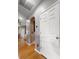 Hallway with hardwood floors, archway, neutral paint, and white doors create an open and inviting atmosphere at 9411 Harroway Rd, Summerville, SC 29485