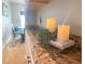 Close-up view of kitchen counter decoration with candle set and dining area in the blurred background at 9411 Harroway Rd, Summerville, SC 29485