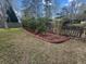 Backyard landscaping along the fence line with decorative curbing, mulch, shrubs and solar lighting for evening ambiance at 9411 Harroway Rd, Summerville, SC 29485