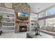 Inviting living room with a stone fireplace, built-in bookshelves, and comfortable seating next to the windows at 9411 Harroway Rd, Summerville, SC 29485