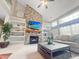 Spacious living room boasts vaulted ceilings, a stone fireplace, built-in shelving, and large windows for natural light at 9411 Harroway Rd, Summerville, SC 29485
