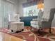 Living room showcasing neutral decor, a patterned rug, and two upholstered armchairs and ottoman at 9411 Harroway Rd, Summerville, SC 29485