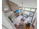 An elevated view of a modern living room with a stone fireplace, built-in shelves and plenty of natural light at 9411 Harroway Rd, Summerville, SC 29485