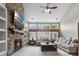 Cozy living room with stone fireplace, built-in shelves, and ample natural light at 9411 Harroway Rd, Summerville, SC 29485