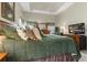 Relaxing main bedroom with green quilted comforter and decorative pillows at 9411 Harroway Rd, Summerville, SC 29485