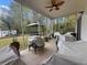 Screened in porch featuring a tile floor, outdoor furniture covers, and a ceiling fan at 9411 Harroway Rd, Summerville, SC 29485
