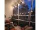 Cozy screened porch with comfortable seating, perfect for relaxing and enjoying the outdoors at 9411 Harroway Rd, Summerville, SC 29485