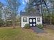Charming shed with a unique barn-style door, perfect for storing gardening tools and outdoor equipment at 9411 Harroway Rd, Summerville, SC 29485