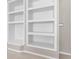 White built in shelves in a bonus room with three shelves at 9411 Harroway Rd, Summerville, SC 29485