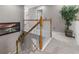 A carpeted staircase with a wood banister and white rails with a potted plant on the landing at 9411 Harroway Rd, Summerville, SC 29485