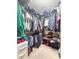 Organized walk-in closet with clothes, bags, and storage shelves at 9411 Harroway Rd, Summerville, SC 29485