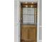 Detail of custom bar featuring glass shelves, lighting, and storage cabinets at 1 King St # 209/210, Charleston, SC 29401