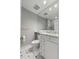 Well-lit bathroom with marble countertop, white cabinetry, and classic black-and-white tile floor at 1 King St # 209/210, Charleston, SC 29401