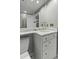 Elegant bathroom features a marble countertop, white vanity, and gold fixtures at 1 King St # 209/210, Charleston, SC 29401