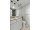 Bathroom featuring a marble countertop, vanity, toilet, and a shower reflected in the mirror at 1 King St # 209/210, Charleston, SC 29401