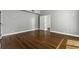 Spacious bedroom featuring hardwood floors, neutral paint, and an adjacent doorway at 1 King St # 209/210, Charleston, SC 29401