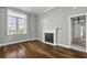 Inviting bedroom with a decorative fireplace, hardwood floors, and large window at 1 King St # 209/210, Charleston, SC 29401