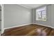 Serene bedroom with hardwood floors and large window featuring plantation shutters at 1 King St # 209/210, Charleston, SC 29401