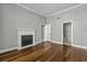 Cozy bedroom featuring hardwood floors and classic fireplace, with a doorway to bath at 1 King St # 209/210, Charleston, SC 29401