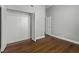 Bedroom showcasing hardwood floors, closet with louvered doors, and access to another room at 1 King St # 209/210, Charleston, SC 29401