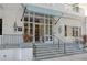 Building entrance with stone steps and planters at 1 King St # 209/210, Charleston, SC 29401