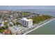 Attractive aerial view of a building with a parking lot, pool, and nearby water views at 1 King St # 209/210, Charleston, SC 29401