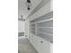 Hallway with built-in shelves and cabinets and decorative lighting fixtures at 1 King St # 209/210, Charleston, SC 29401