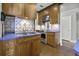 Kitchen showcasing wooden cabinets, blue countertops, patterned tile, and stainless steel appliances at 1 King St # 209/210, Charleston, SC 29401