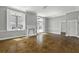 Open-concept living room with fireplace, natural light and hardwood floors at 1 King St # 209/210, Charleston, SC 29401