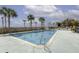 Community pool surrounded by palm trees and lush landscaping at 1 King St # 209/210, Charleston, SC 29401