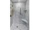 Luxurious marble shower with gold fixtures and convenient corner shelves at 1 King St # 209/210, Charleston, SC 29401
