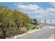 Scenic view of waterfront park with palm trees and harbor in desirable location at 1 King St # 209/210, Charleston, SC 29401