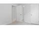 A bedroom with neutral gray carpet, white walls and trim with open doors to other rooms at 1019 Swamp Rose Run, Summerville, SC 29485