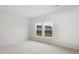 Bright bedroom with plush carpet and double windows offering a view of the surrounding neighborhood at 1019 Swamp Rose Run, Summerville, SC 29485