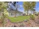 Landscaped backyard with lawn, patio, and a charming garden bed at 102 Brutus Ln, Summerville, SC 29485