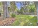 Spacious backyard with lawn, mature trees, and perimeter privacy fence at 102 Brutus Ln, Summerville, SC 29485