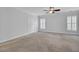 Spacious bedroom with neutral carpet, ceiling fan, and natural light from shuttered windows at 102 Brutus Ln, Summerville, SC 29485