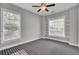 Bedroom featuring windows with decorative built-in shelving, a ceiling fan and patterned carpet at 102 Brutus Ln, Summerville, SC 29485