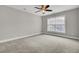 Neutral bedroom featuring wall-to-wall carpet, a ceiling fan, and a window at 102 Brutus Ln, Summerville, SC 29485