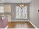 Dining Room with chandelier, large window with shutters, and access to kitchen and living areas at 102 Brutus Ln, Summerville, SC 29485