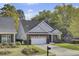 Charming brick home with a well-manicured lawn, two-car garage, and lush trees at 102 Brutus Ln, Summerville, SC 29485