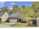 Charming brick home with a well-manicured lawn, two-car garage, and lush trees at 102 Brutus Ln, Summerville, SC 29485